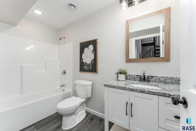 full bathroom with vanity, hardwood / wood-style flooring, toilet, and shower / bathtub combination