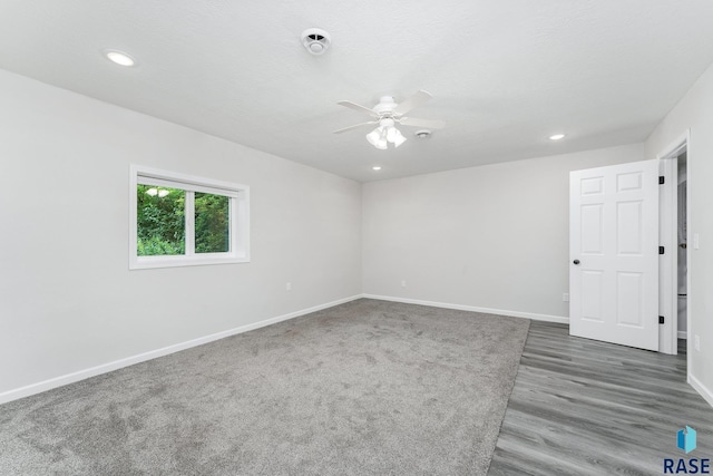 spare room with a textured ceiling, dark hardwood / wood-style flooring, and ceiling fan