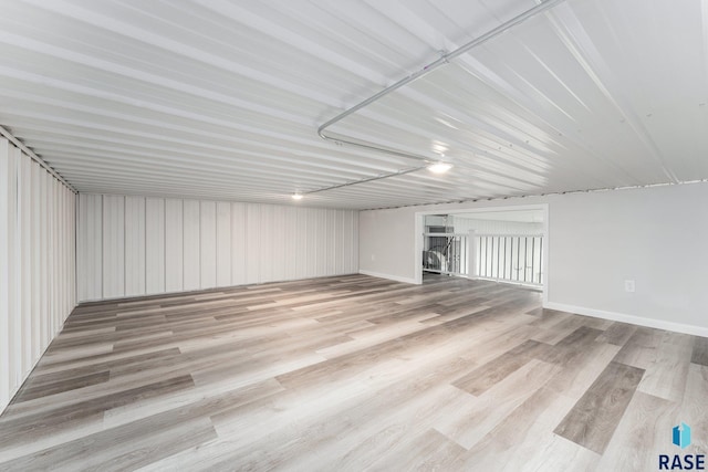 basement with light hardwood / wood-style floors