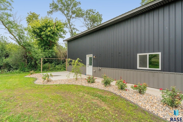 view of home's exterior featuring a patio area and a lawn