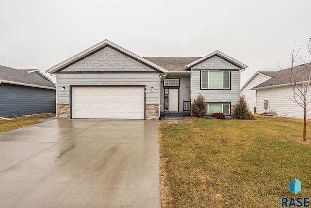 view of front of home featuring a garage and a front lawn