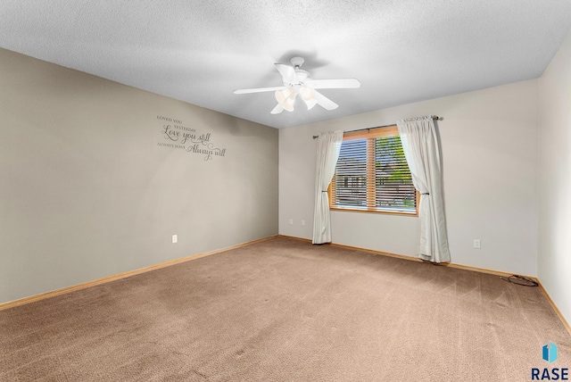 carpeted spare room featuring ceiling fan and a textured ceiling