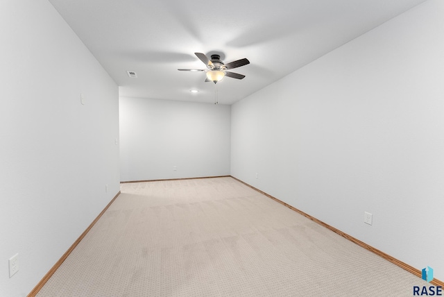 carpeted spare room with ceiling fan