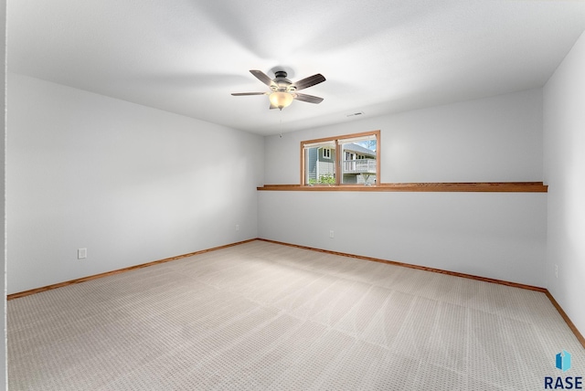 spare room featuring carpet flooring and ceiling fan