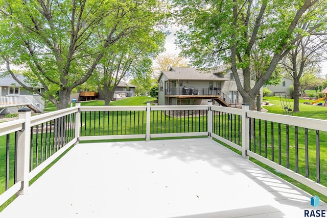 wooden terrace with a lawn