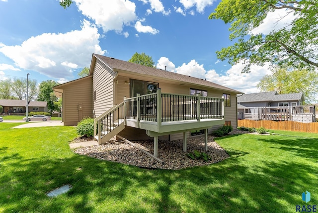 back of property with a lawn and a wooden deck