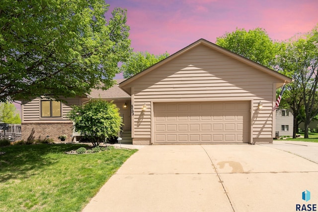 ranch-style house with a lawn and a garage