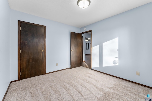 unfurnished bedroom featuring carpet flooring and a closet