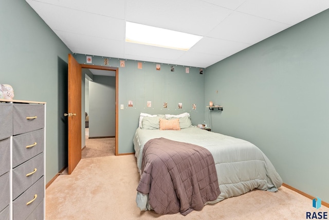 carpeted bedroom with a paneled ceiling