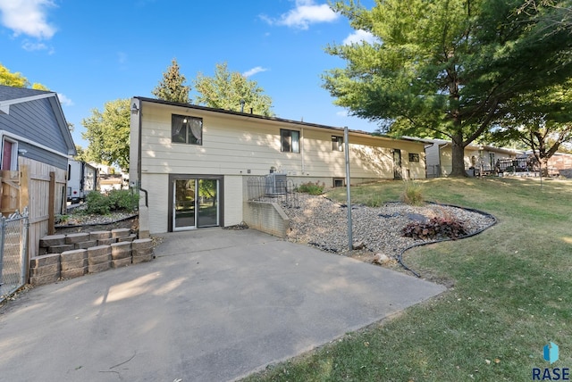 back of house featuring a yard and a patio area