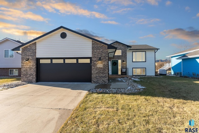 view of front of house with a yard and a garage