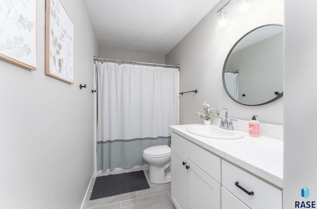 bathroom with tile patterned floors, vanity, and toilet