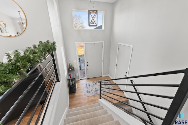 entrance foyer with wood-type flooring and an inviting chandelier