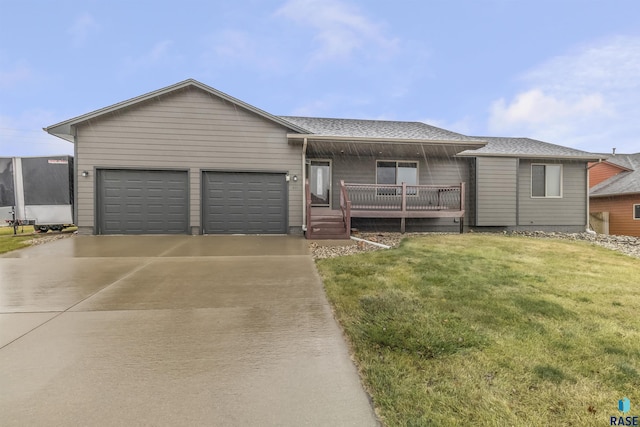 ranch-style home featuring a garage, a deck, and a front lawn