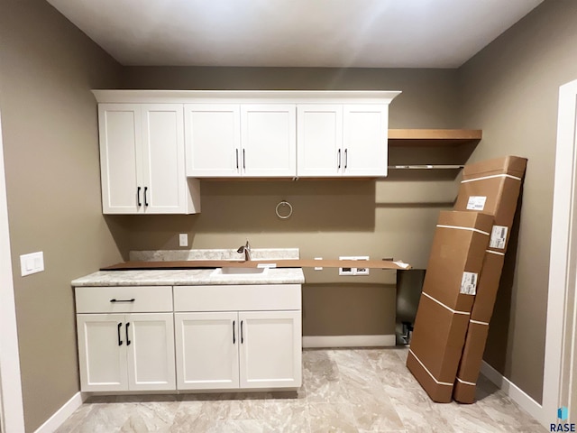 kitchen with white cabinetry and sink