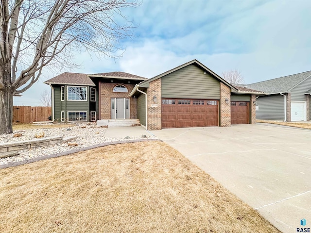 view of front of house featuring a garage and a front lawn