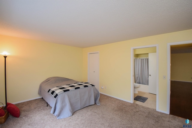 bedroom with carpet floors and ensuite bathroom