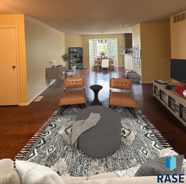 living room featuring dark hardwood / wood-style flooring and a textured ceiling