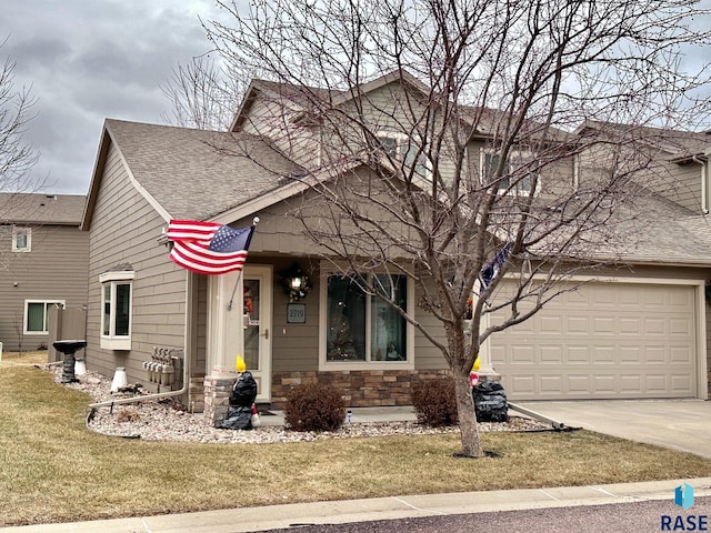 view of front of property featuring a garage and a front lawn