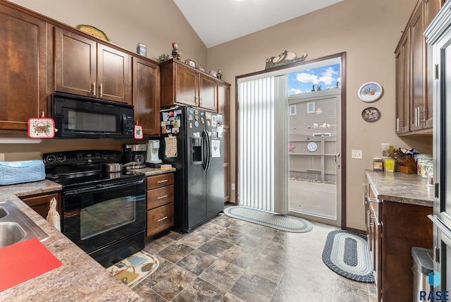 kitchen with black appliances, sink, and vaulted ceiling