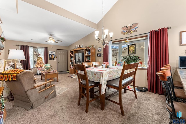 dining space featuring ceiling fan with notable chandelier, light colored carpet, and lofted ceiling