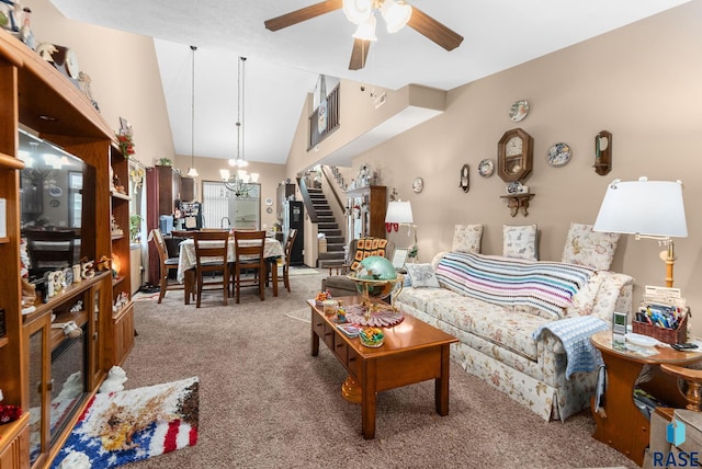 carpeted living room with high vaulted ceiling and ceiling fan with notable chandelier