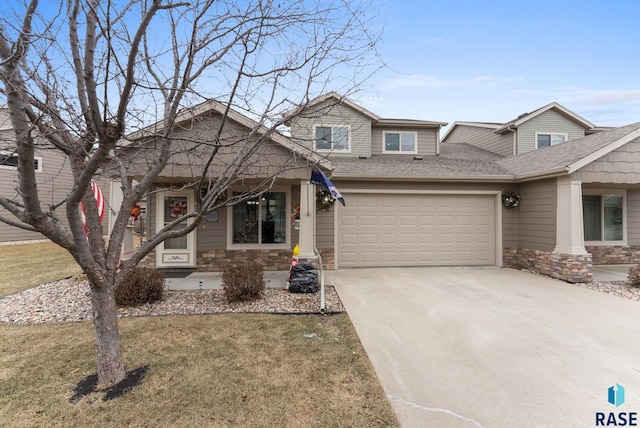 craftsman-style house with a front lawn and a garage