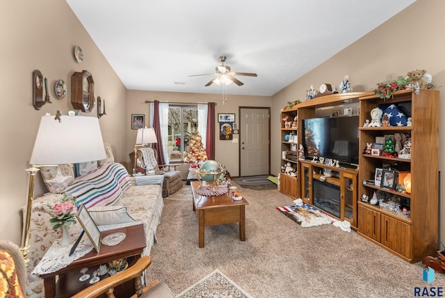 carpeted living room featuring ceiling fan and a fireplace