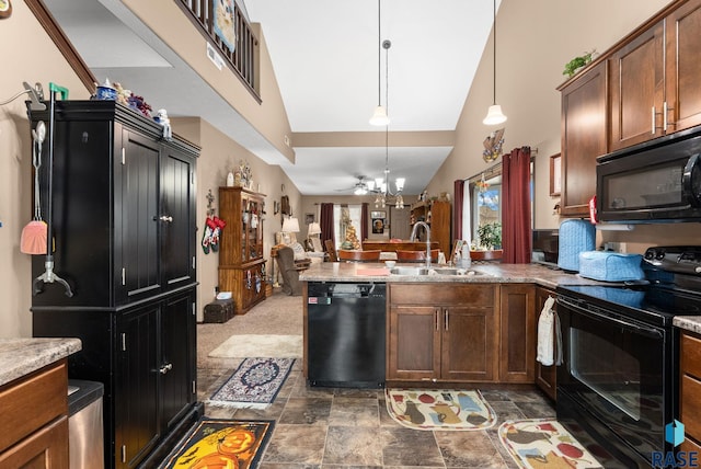 kitchen with black appliances, sink, hanging light fixtures, vaulted ceiling, and kitchen peninsula