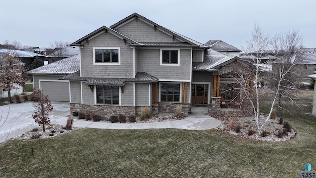 craftsman-style home with a front yard and a garage