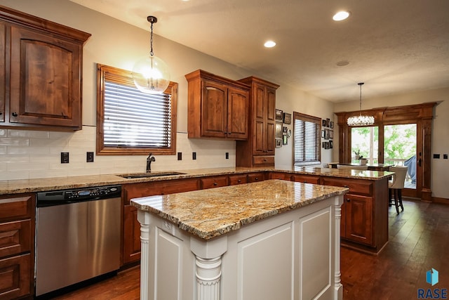 kitchen with a center island, a notable chandelier, sink, decorative light fixtures, and stainless steel dishwasher