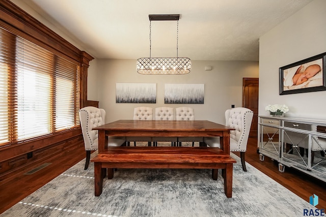 dining space with dark hardwood / wood-style flooring and a wealth of natural light