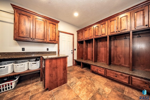 mudroom with a textured ceiling