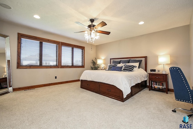 bedroom featuring ceiling fan, light colored carpet, and a textured ceiling