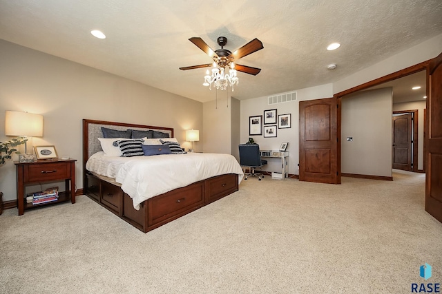 bedroom with ceiling fan, light colored carpet, and a textured ceiling