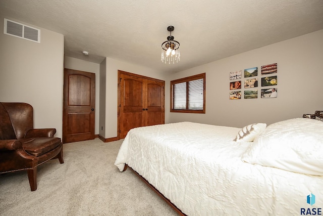 carpeted bedroom featuring a textured ceiling