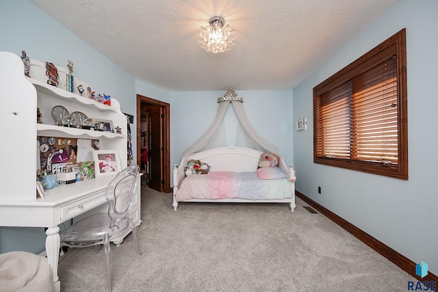 carpeted bedroom with a textured ceiling