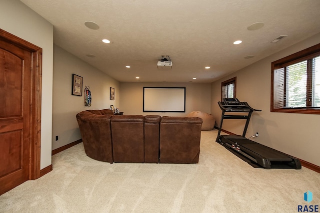 carpeted home theater with a textured ceiling