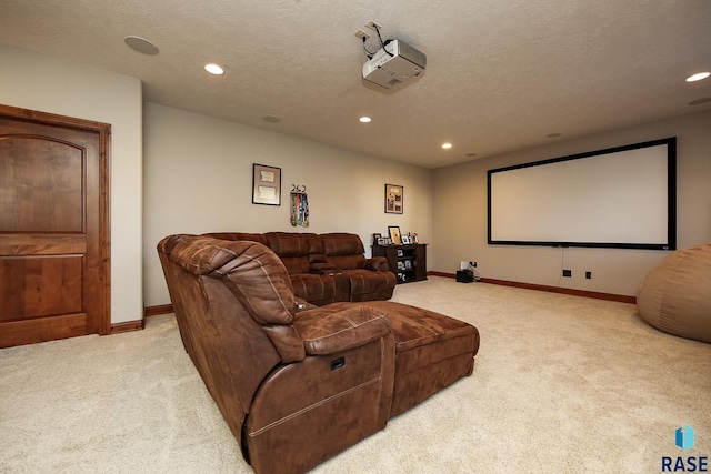 home theater room featuring a textured ceiling and light carpet