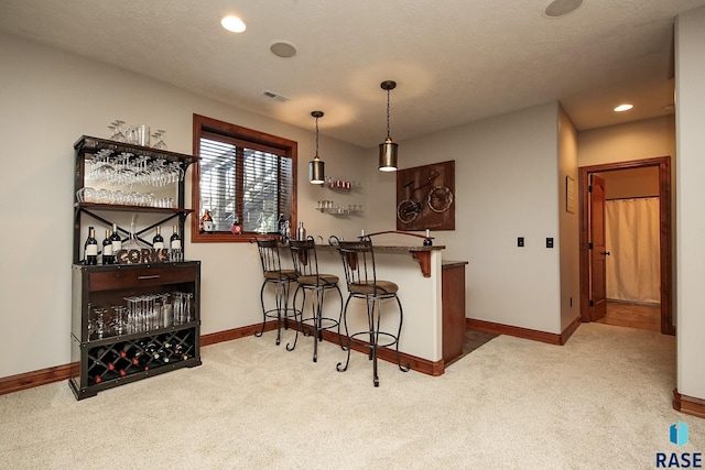 bar with decorative light fixtures and light carpet