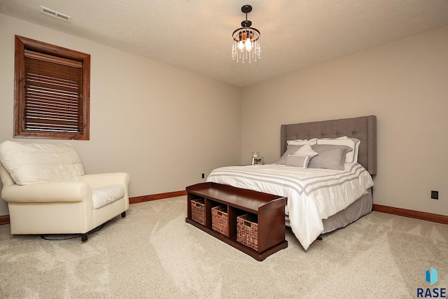 bedroom featuring a notable chandelier and light colored carpet