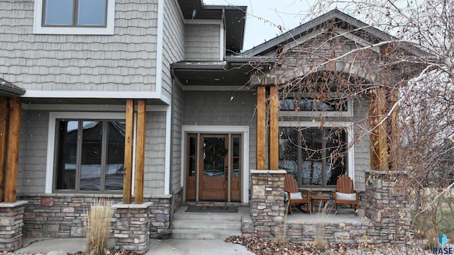 view of exterior entry featuring a porch