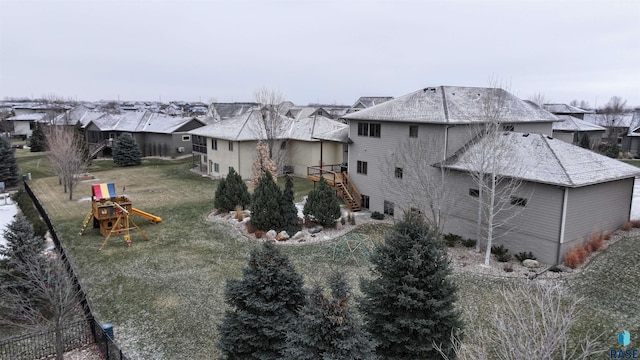 exterior space with a playground and a lawn