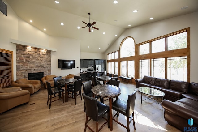 living room featuring high vaulted ceiling, ceiling fan, and a healthy amount of sunlight