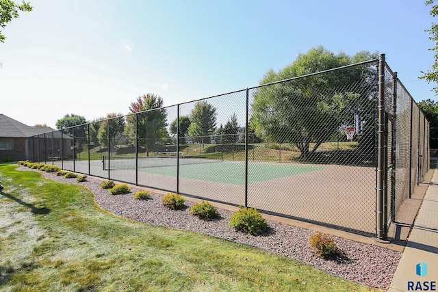 view of tennis court featuring basketball hoop