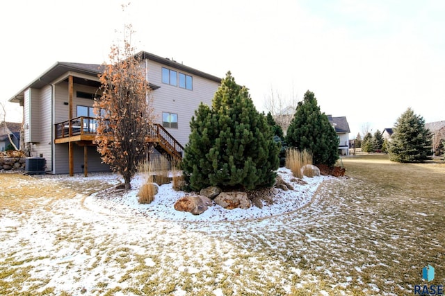 snow covered property with a wooden deck