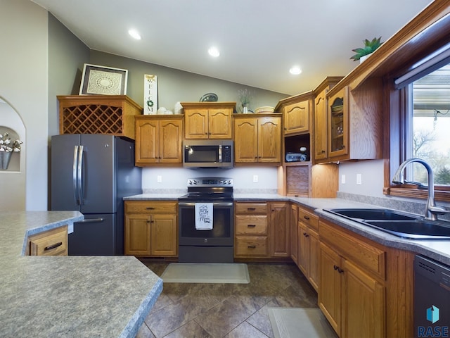 kitchen with lofted ceiling, sink, and appliances with stainless steel finishes