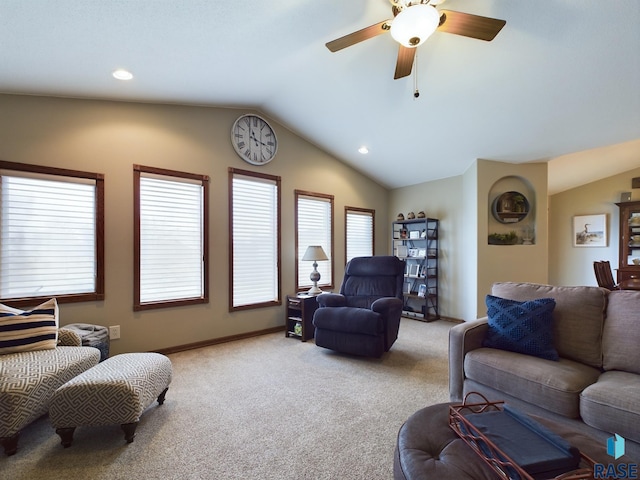 carpeted living room with ceiling fan and lofted ceiling