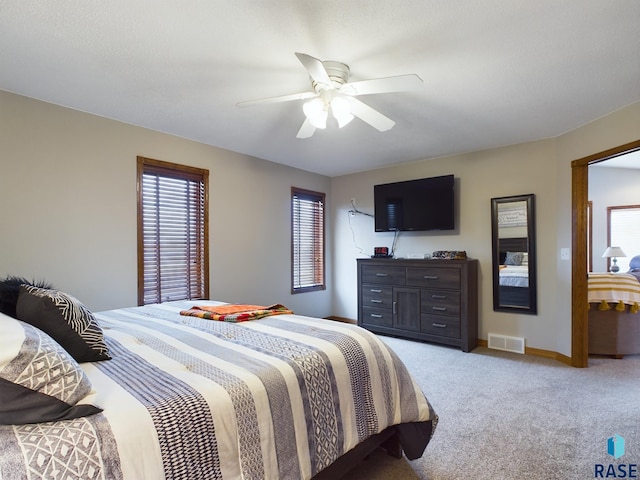 bedroom featuring light colored carpet and ceiling fan