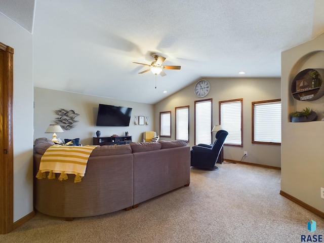 living room with carpet flooring, ceiling fan, and vaulted ceiling